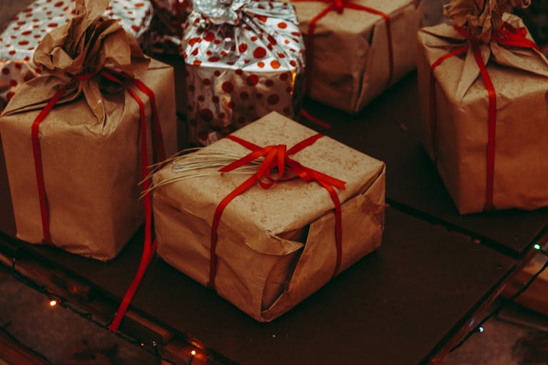 Charming rustic presents with brown paper and red ribbons, perfect for festive occasions.